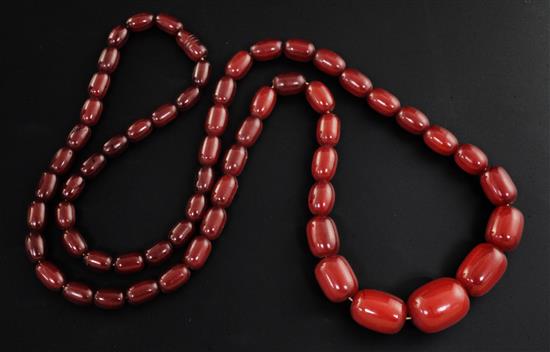 A single strand graduated simulated cherry amber bead necklace, 92cm.